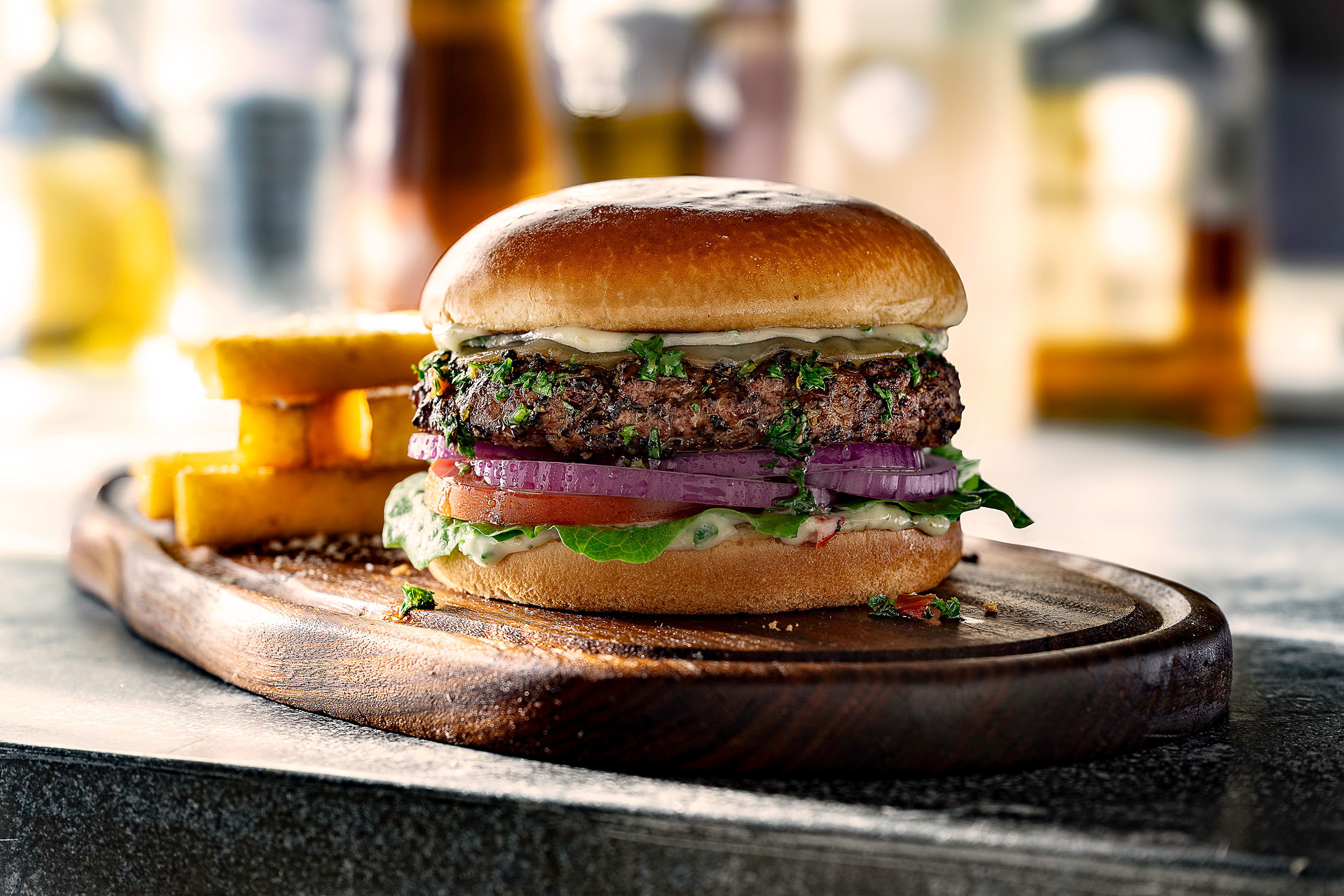 Juicy burger on a plank of wood